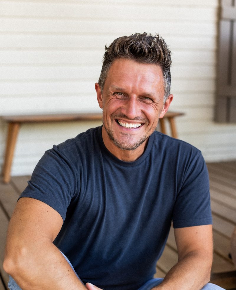 Alex Bond, founder of Bond Bookkeeping & Advisory, smiling on a front porch